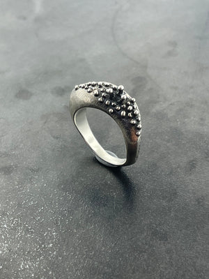 In Flow ring with knobbly  and scratch textures