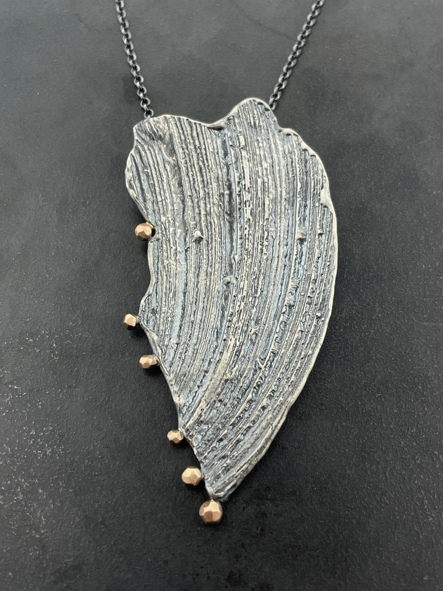 Impressions necklace with peach gold accents