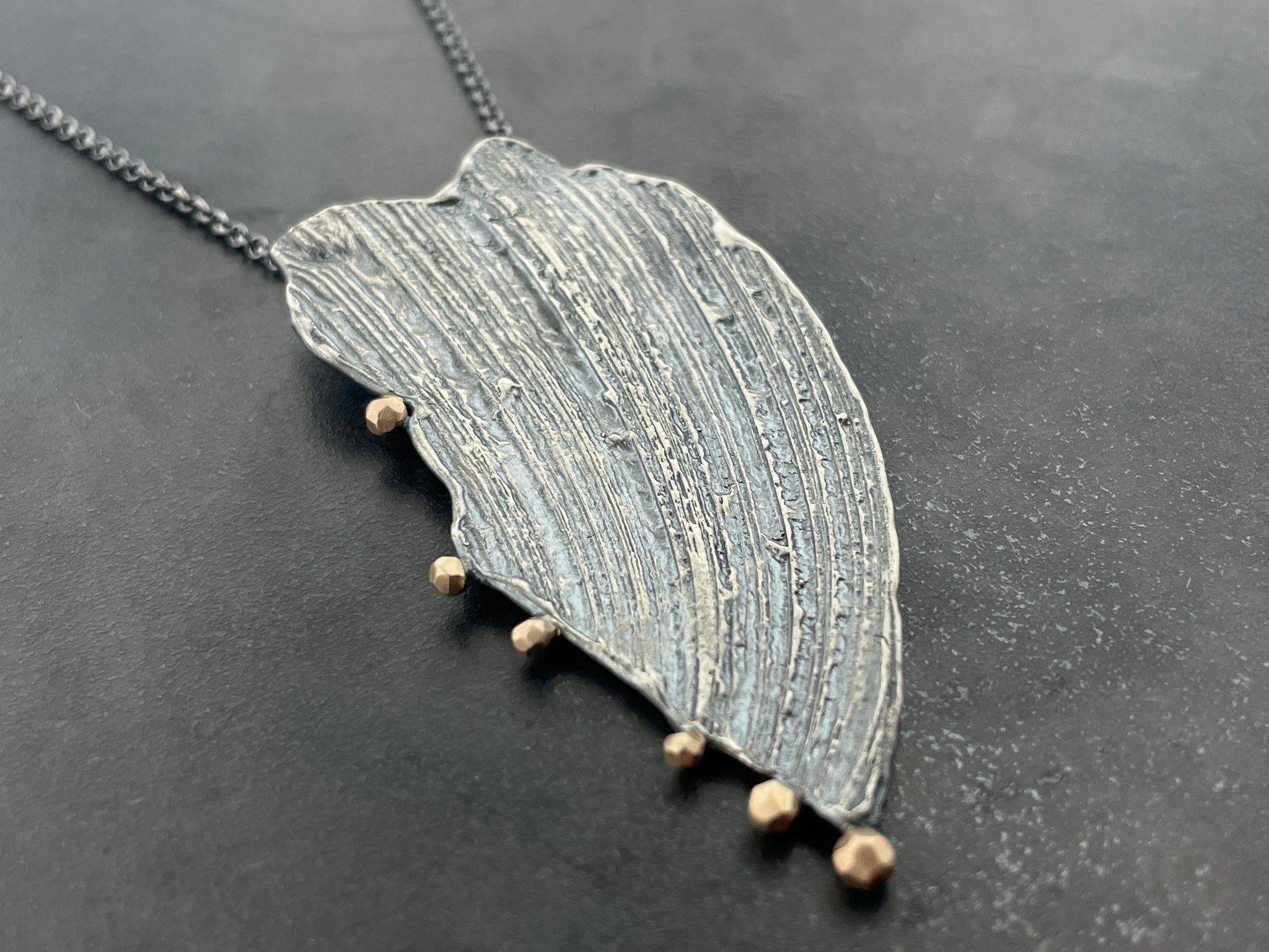 Impressions necklace with peach gold accents